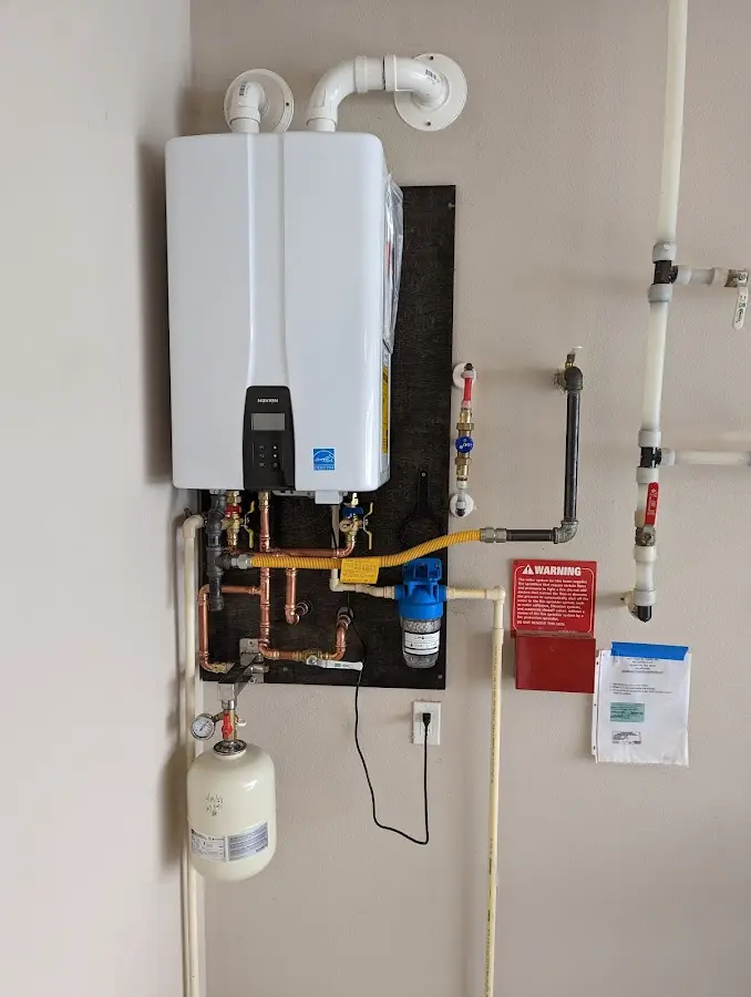 Professional plumber installing copper piping in a Molalla home
